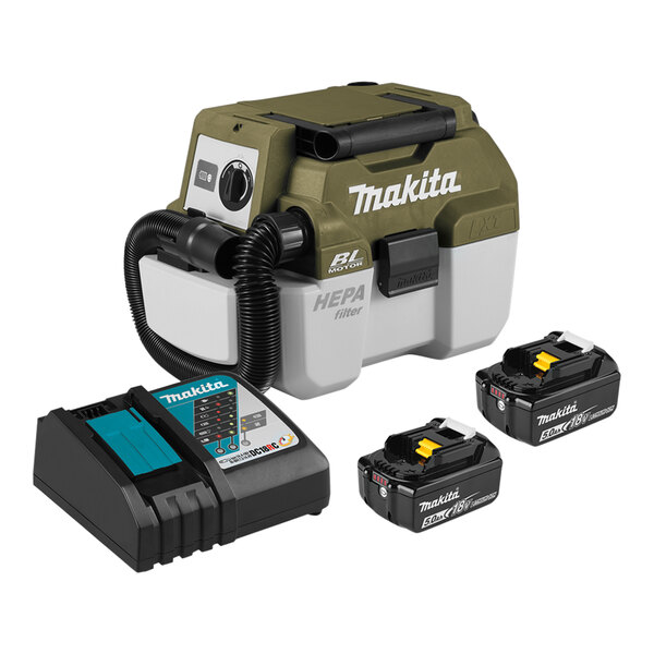 A green and grey Makita wet/dry vacuum machine with black batteries attached.