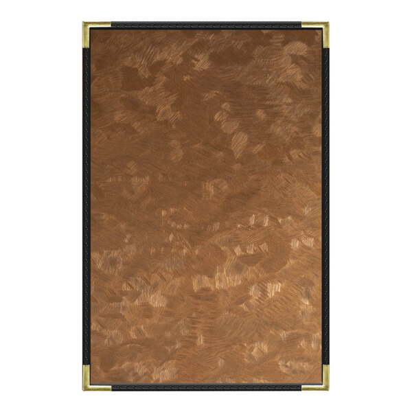 A brown brushed metallic menu cover with a gold frame on a brown surface.