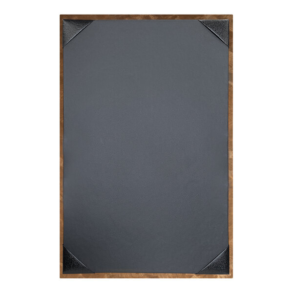 The corner of a black menu cover with a brushed metallic gold frame.