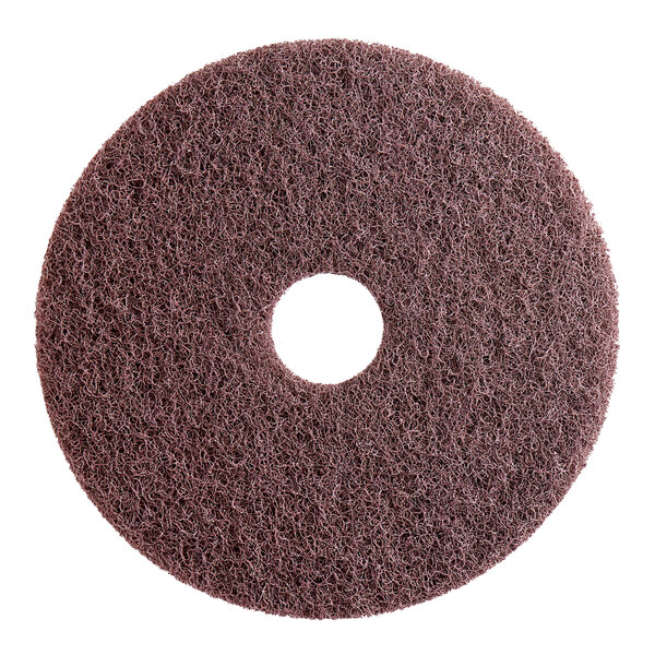 A brown circular Lavex Pro stripping pad with a hole in the middle.