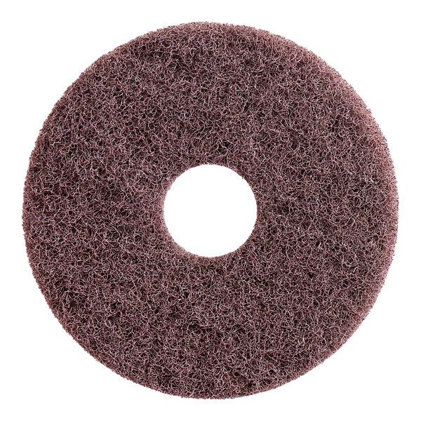 A brown circular Lavex Pro stripping floor pad with a hole in the middle.