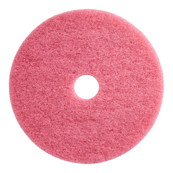 A pink Lavex Auto Scrubber floor pad with a hole in the middle.