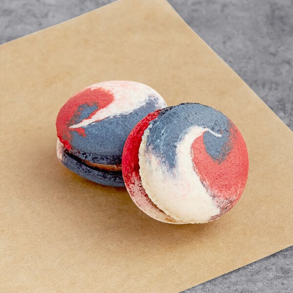 Two Macaron Centrale Rocky Road macarons with red, white, and blue shells.