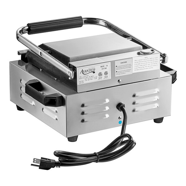 An Avantco silver rectangular electric commercial panini grill with a cord attached.