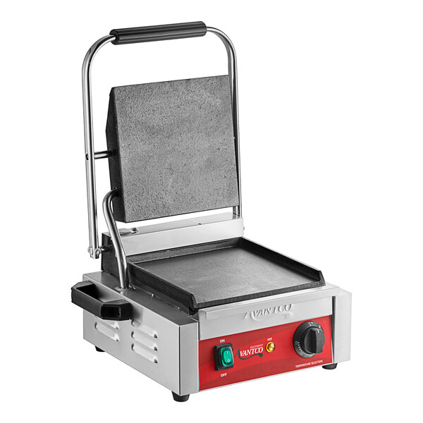 An Avantco commercial panini grill with smooth plates and a red handle.