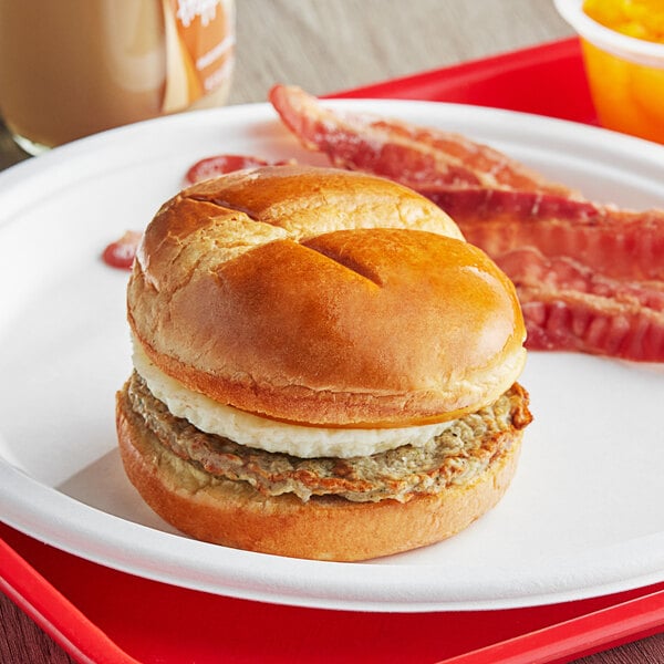 A Grand Prairie Brioche breakfast sandwich on a white plate.