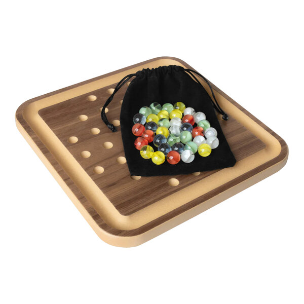 A bag of marbles on a wooden board.