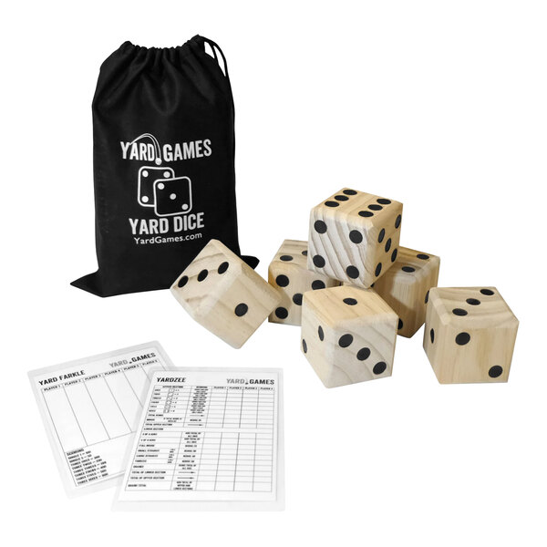 A group of Yard Games wooden dice with black dots in a black bag next to score sheets.