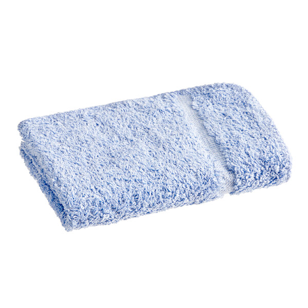 A blue Fibertone washcloth on a white background.