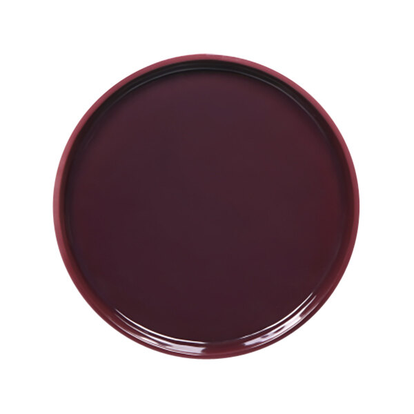 A round purple melamine plate with a red reactive glaze on a white background.