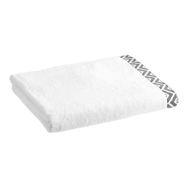 A white towel with a gray chevron border.