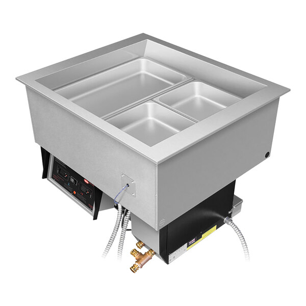 A Hatco drop-in hot food well with three compartments on a counter with food in it.