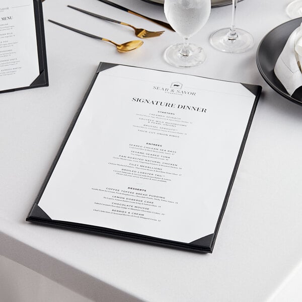 A white table with a black Acopa Prime menu board on it.