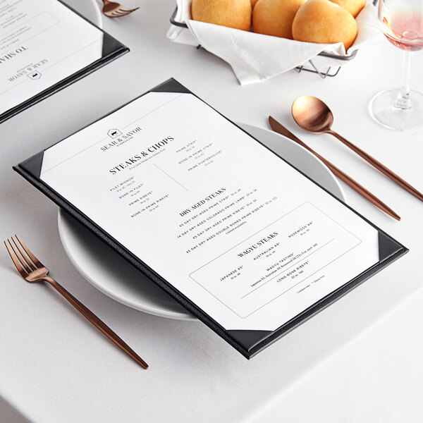 A menu on a table with food on a plate.