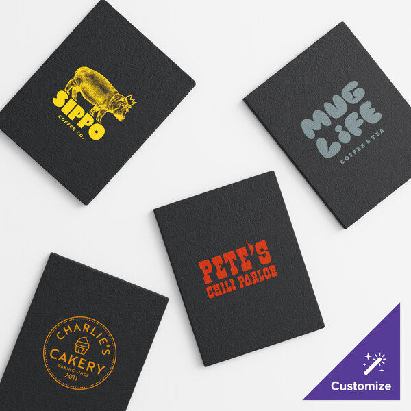 A set of four black vinyl menu booklets with custom printed logos and text on the covers.