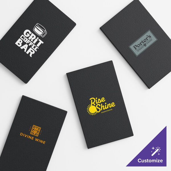 A set of black customizable vinyl menu booklets with various business logos displayed on the covers.