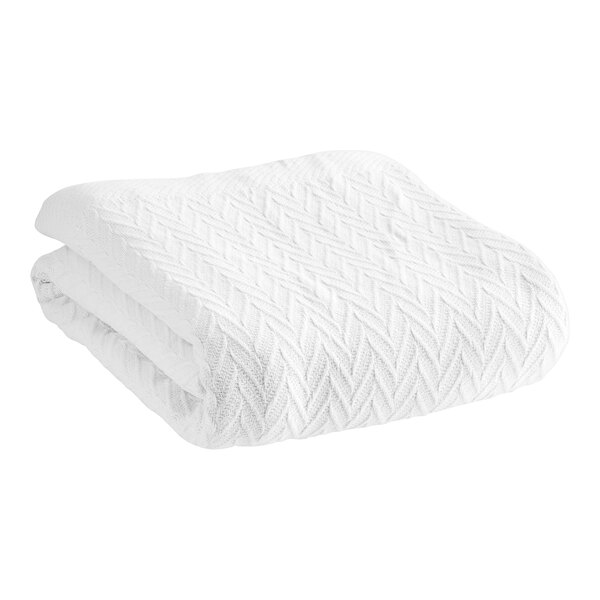 A white 1888 Mills Magnificence thermal herringbone blanket with a chevron pattern.