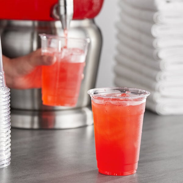 A hand pouring Gatorade Thirst Quencher Fruit Punch into a glass.