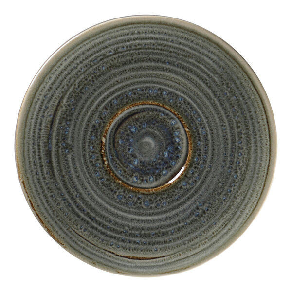 A close-up of a RAK Porcelain peridot saucer with a circular spot design in the center.