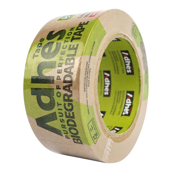 A roll of Adhes biodegradable natural rubber Kraft packaging tape with green and brown paper packaging and green text.