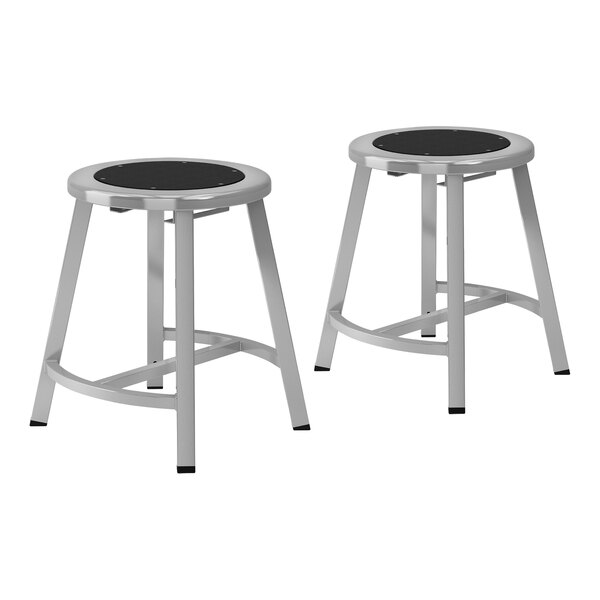 Two National Public Seating metal lab stools with black seats.