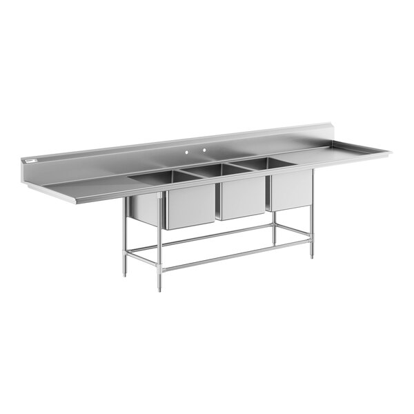 A stainless steel commercial sink with three deep basins, two drainboards, and a backsplash, supported by metal legs.