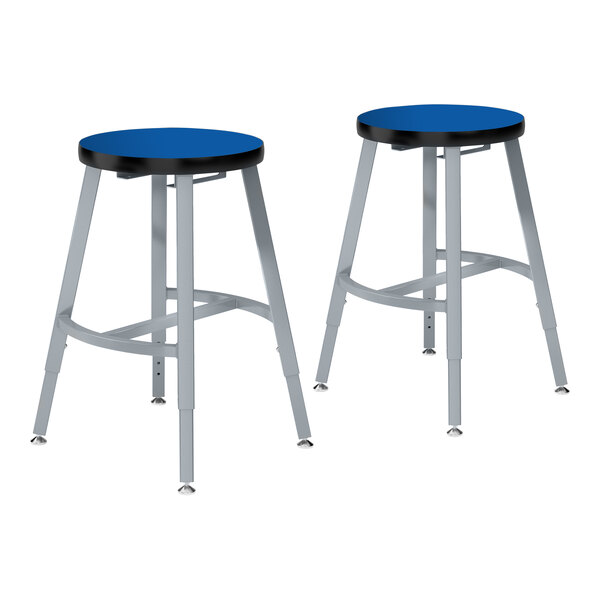 A pair of National Public Seating lab stools with gray metal legs and blue seats.