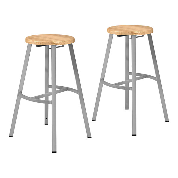 Two National Public Seating metal lab stools with oak seats.