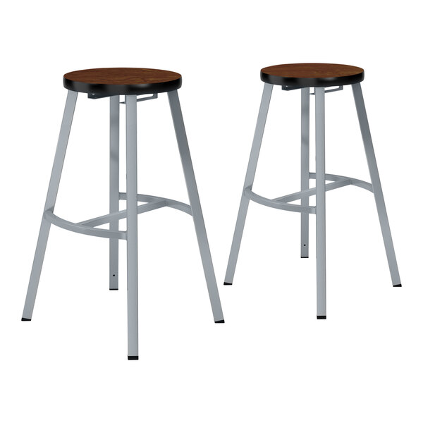 Two National Public Seating metal lab stools with Montana walnut high-pressure laminate seats.