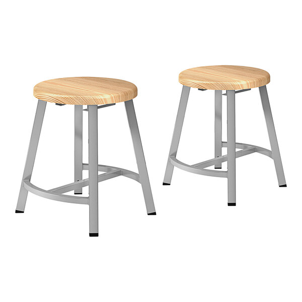 A pair of National Public Seating Titan lab stools with wooden seats.
