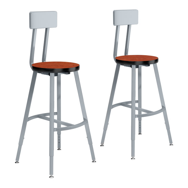 A pair of National Public Seating Titan lab stools with a cherry seat and backrest.