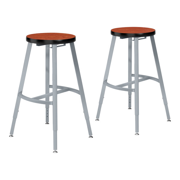 A pair of National Public Seating metal lab stools with Wild Cherry laminate seats.