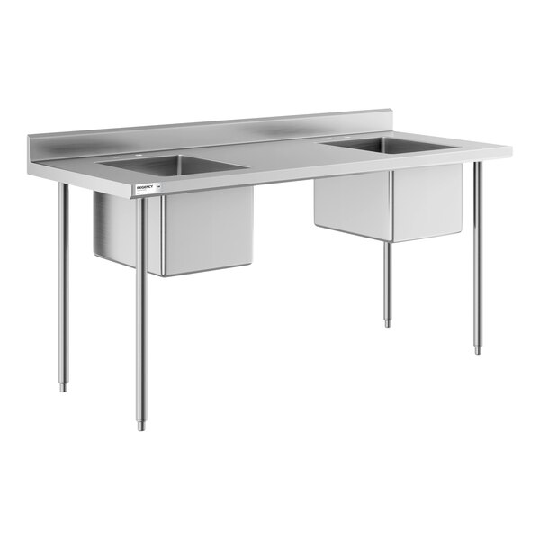 A stainless steel work table with two integrated square sinks and four legs.
