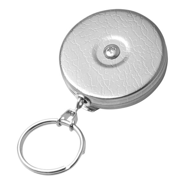 A close-up of a silver metal KEY-BAK key chain with a split ring.