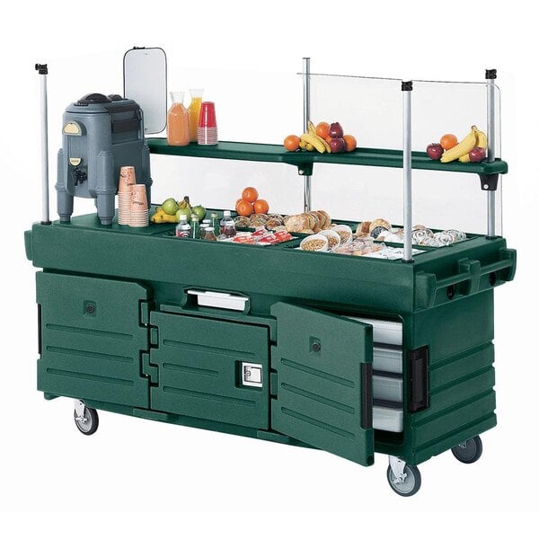 A green Cambro CamKiosk vending cart with food in pan wells.