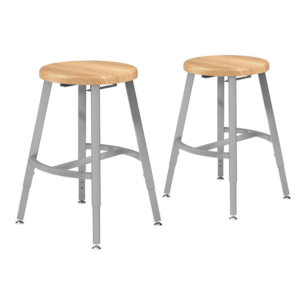 Two National Public Seating metal lab stools with oak seats.