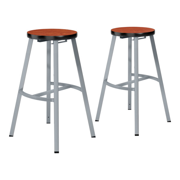 A pair of National Public Seating gray steel lab stools with Wild Cherry high-pressure laminate seats.