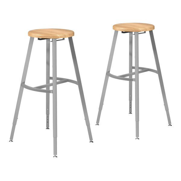 Two National Public Seating lab stools with oak seats and backs.