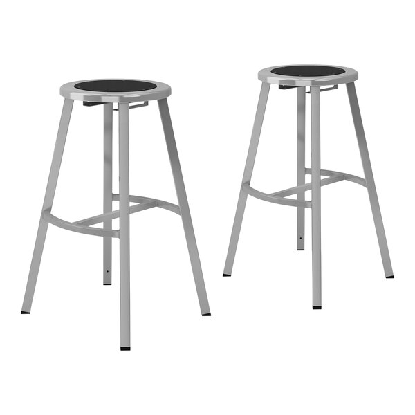 Two National Public Seating steel lab stools with black seats and legs.