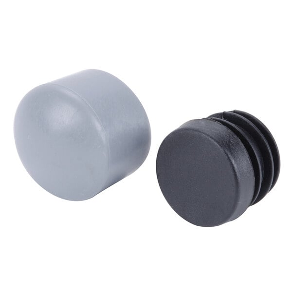 Two grey plastic caps with a black knob on a white background.