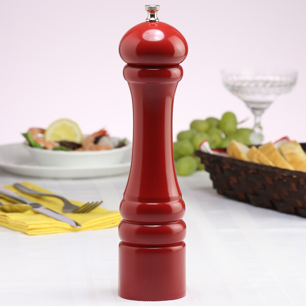 A Chef Specialties candy apple red pepper mill on a table.