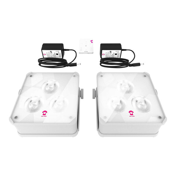 Two white square Ape Labs Maxi 2.0 LED lights with black chargers and a remote.