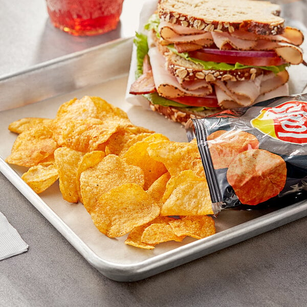 A tray with a sandwich and Lay's Barbecue potato chips on it.