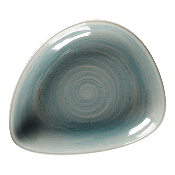 A close-up of a RAK Porcelain Sapphire Porcelain deep organic plate with a blue and white spiral design.