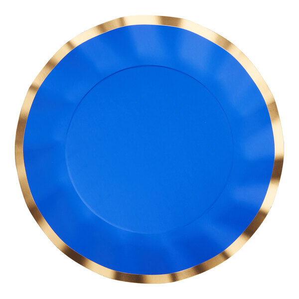 A Sophistiplate blue wavy paper dinner plate with a gold rim on a blue surface.