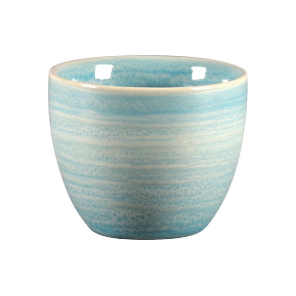 A white porcelain cup with a blue and white stripe and spot.