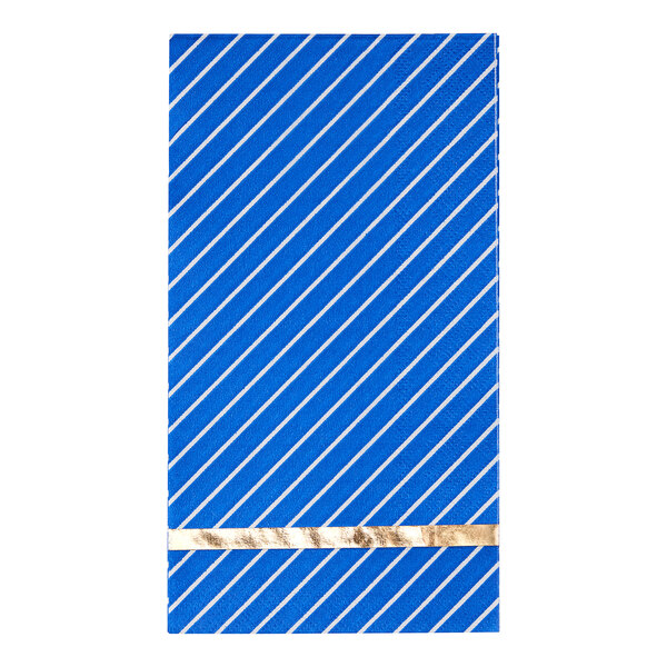 A blue napkin with gold stripes on a table.