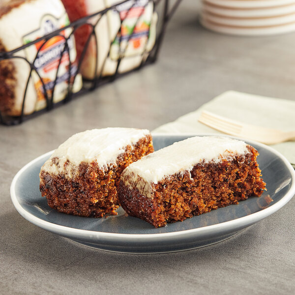 Two Ne-Mo's Bakery carrot cake squares on a plate.