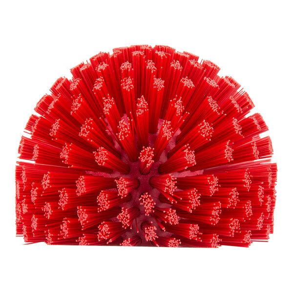 A red plastic Carlisle Sparta brush with many bristles and a handle.