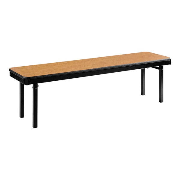 A long brown wooden National Public Seating folding bench with black metal legs.